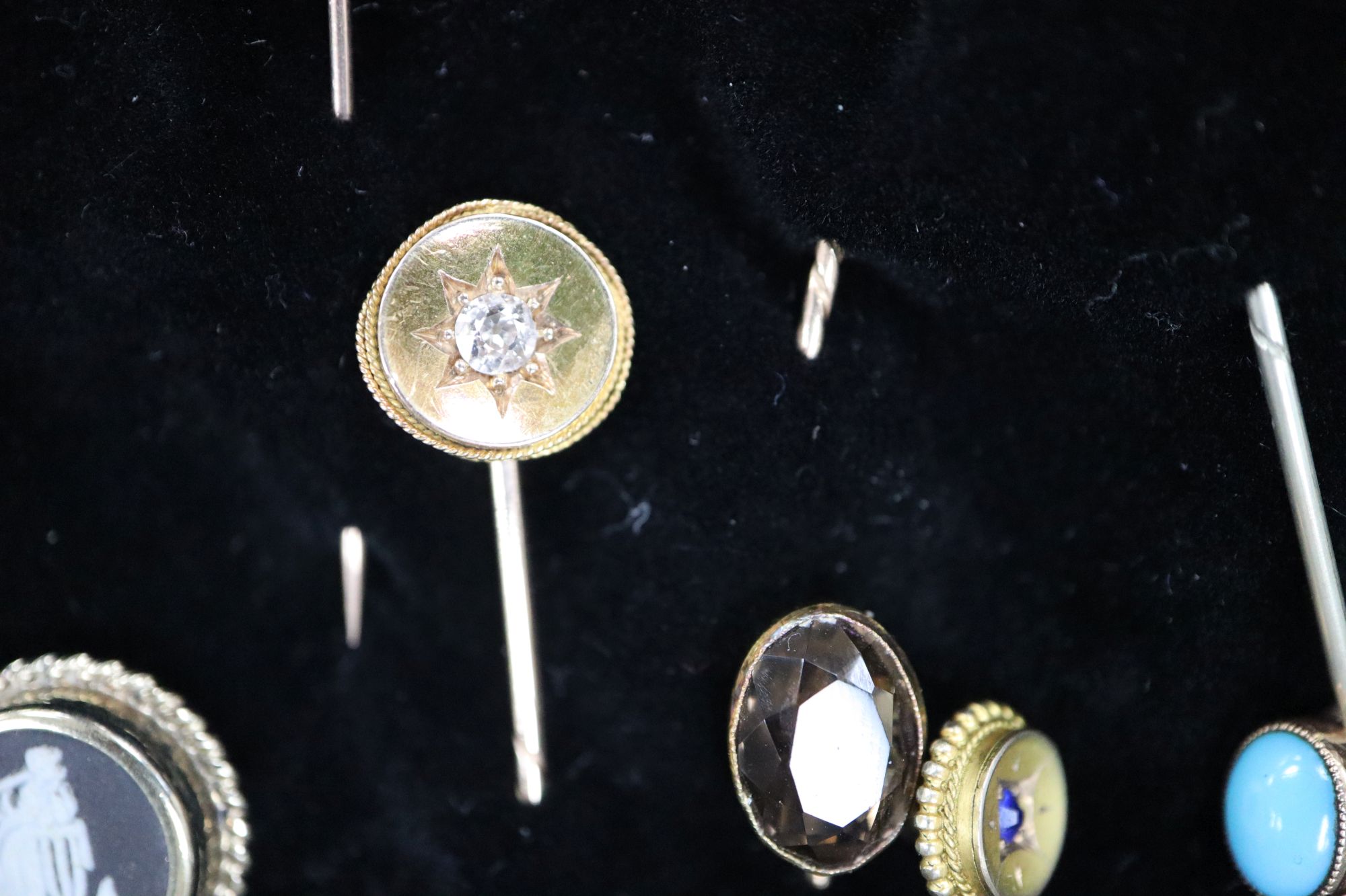 Twenty assorted Victorian and later mainly yellow metal and gem set stick pins